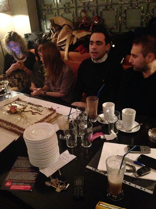 Members of the Association at the table for the cutting of the New Year cake (vasilopita)
